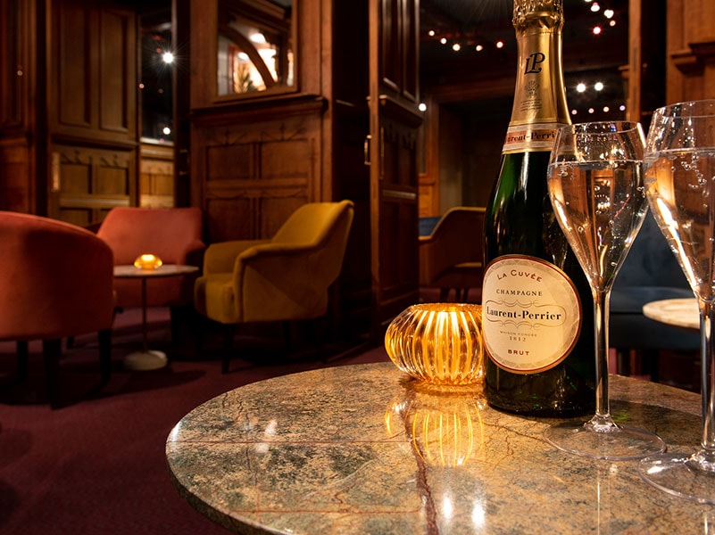 View inside the American Bar at the London Coliseum with a bottle of Laurent Perrier with two glasses in the foreground